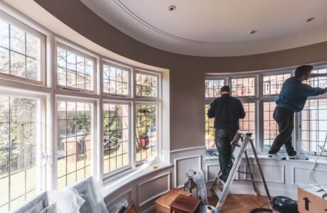 Two lare round bay casement windows with leaded glass